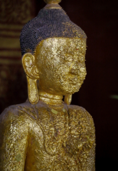 Buddha statue pasted over with lots of gold sheets