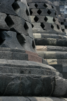 Stupas hiding Buddha statues in the Borobudur temple complex