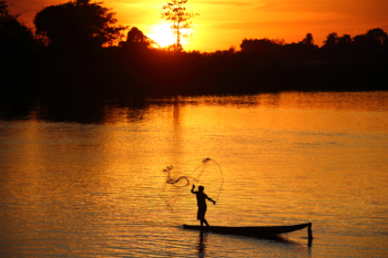 fisherman on the Mekong at sunset in Laos