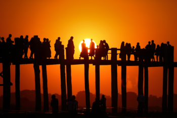 meeting of two monks on a wooden bridge