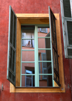 reflection in the window in the old town of Nice, France
